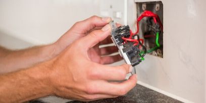 Electrician replacing socket in Virginia home