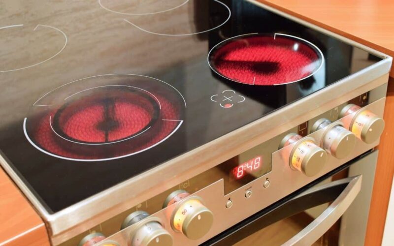 A ceramic electric stove between wood counters