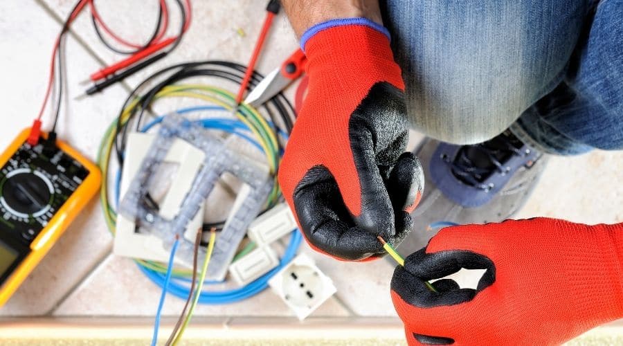 Overhead shot of an electrician handling a yellow wire