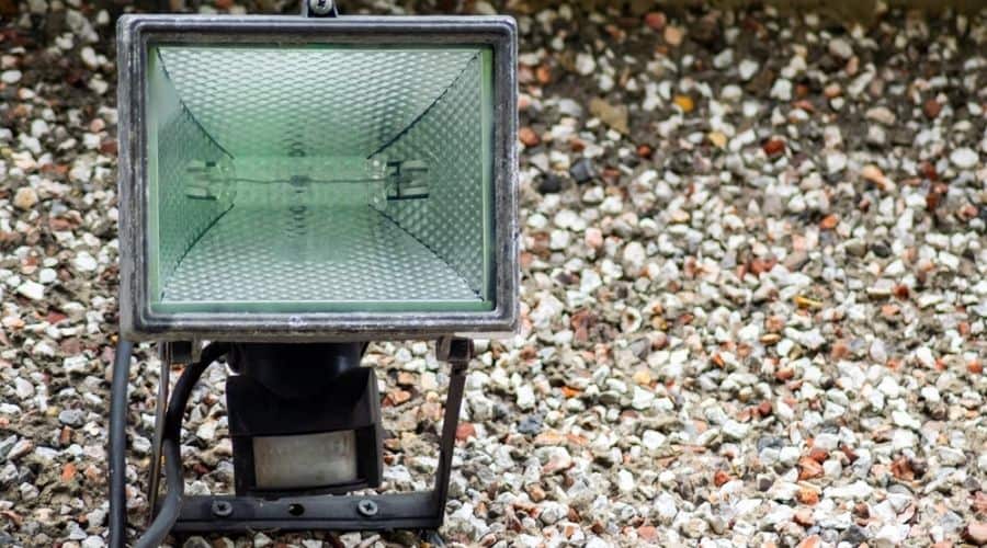 A passive infra-red security light in gravel