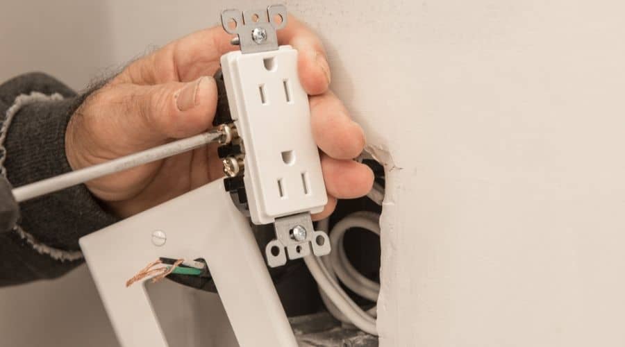 man upgrading electrical outlet