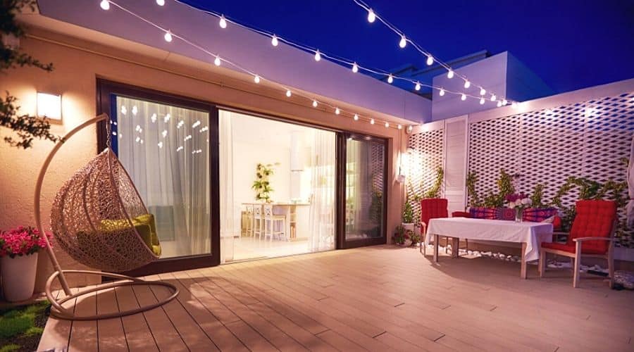 A patio with string lights hanging above it