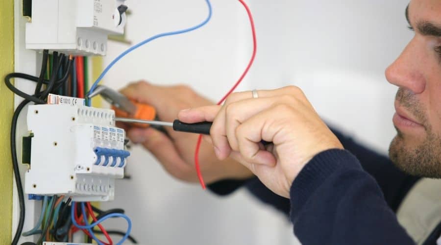 Close-up of an electrician working on a circuit breaker