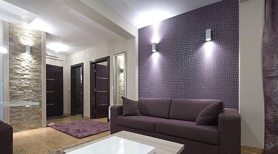 Wall lights throughout a modern-style living room with purple accents
