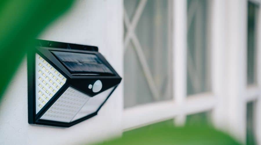 A solar deck light mounted to a wall
