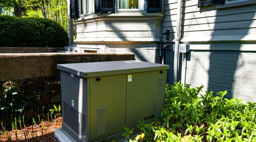 A residential standby generator next to a house