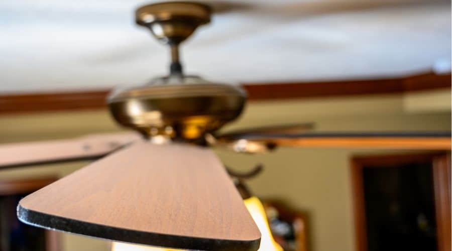 Close-up of unbalanced wood ceiling fan blades