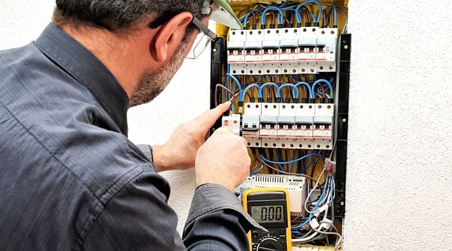 An electrician working in a large circuit breaker