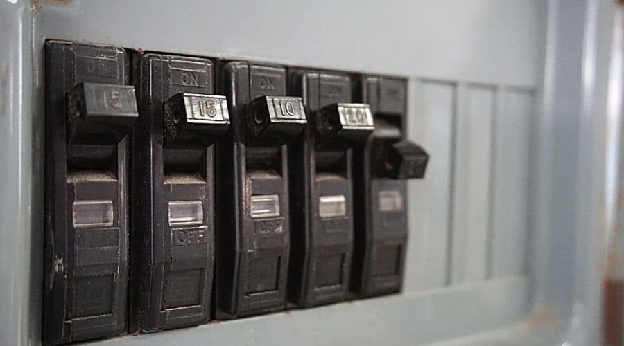 Close-up of a tripped circuit breaker with black switches