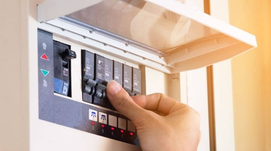 Close-up of somebody flipping a switch in a white circuit breaker