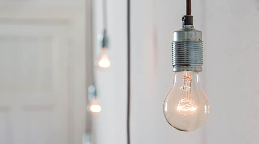 a light bulb hangs against a wall