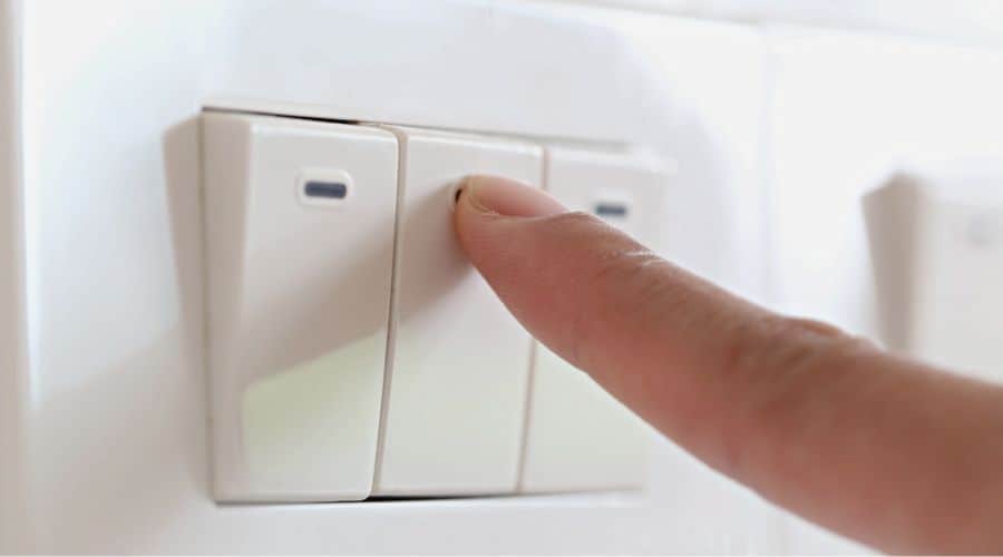 a finger pressing a light switch