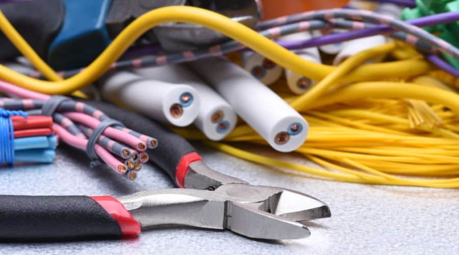 pliers in front of bundles of cut wiring