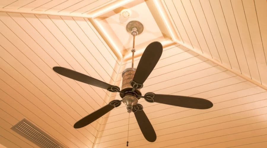 a close u of an extended downrod ceiling fan