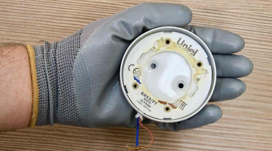 an electrician holds an old wire connection