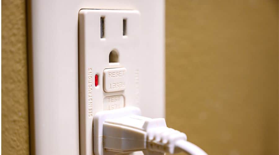 close up image of test and reset buttons on an outlet