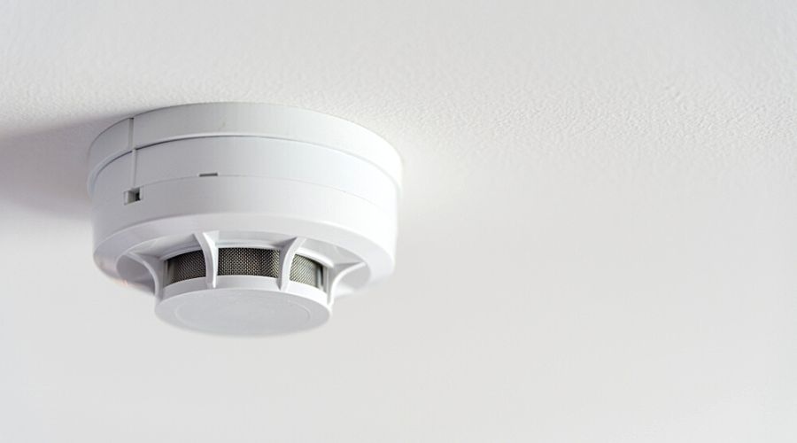 close up of a smoke detector on the ceiling